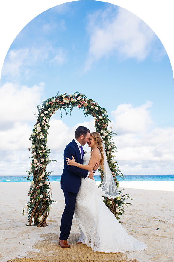 Wedding couple getting married on the beach at a destination wedding.