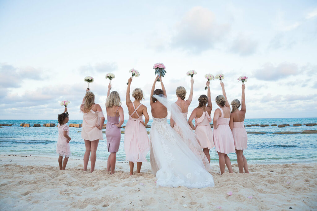 Destination wedding bride and bridesmaids on the beach.