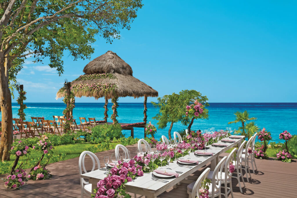 Destination wedding reception at a gazebo next to the beach.