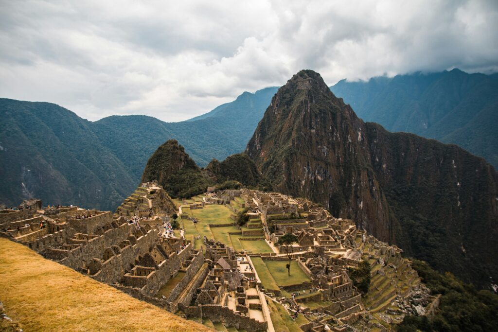 Machu Picchu Inca ruins with terraces and Huayna Picchu mountain in Peru.